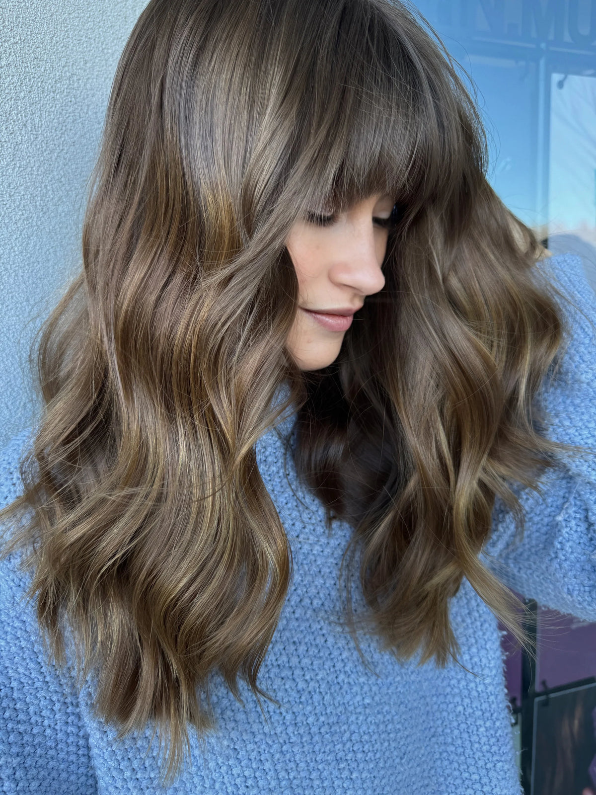 Long wavy light brown hair styled at Wair Studio Salon
