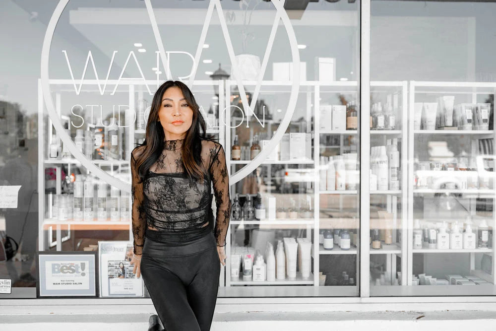 Owner of Wair Studio Salon in front of the salon storefront in Marlton, New Jersey